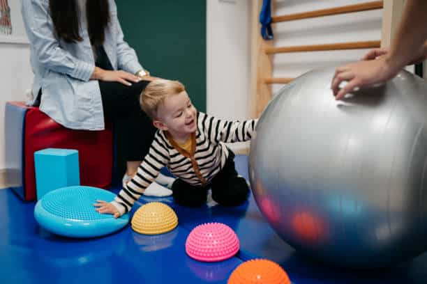 Little Boy playing with his therapist
